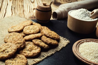 Bisküvi tatlı kurabiye arka plan. Yerli yığılmış tereyağı bisküvi desen kavramı, makro yakından. Ev yapımı kurabiye ahşap masa üzerinde. Mısır gevreği bisküvi susam, yer fıstığı, ayçiçeği ve amaranth.