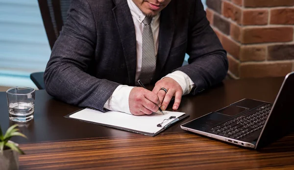 Close up businessman signing documents.Businessman is signing a contract,Man signing a document or writing correspondence