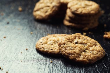 Bisküvi tatlı kurabiye arka plan. Yerli yığılmış tereyağı bisküvi desen kavramı, makro yakından. Ev yapımı kurabiye ahşap masa üzerinde. Mısır gevreği bisküvi susam, yer fıstığı, ayçiçeği ve amaranth.