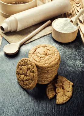 Bisküvi tatlı kurabiye arka plan. Yerli yığılmış tereyağı bisküvi desen kavramı, makro yakından. Ev yapımı kurabiye ahşap masa üzerinde. Mısır gevreği bisküvi susam, yer fıstığı, ayçiçeği ve amaranth.