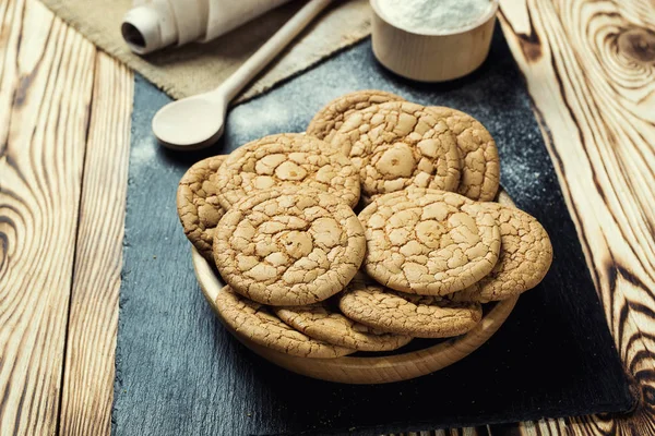 Bisküvi tatlı kurabiye arka plan. Yerli yığılmış tereyağı bisküvi desen kavramı, makro yakından. Ev yapımı kurabiye ahşap masa üzerinde. Mısır gevreği bisküvi susam, yer fıstığı, ayçiçeği ve amaranth.