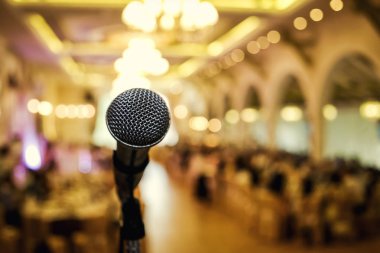 Microphone. A microphone on stage. A pub. Bar. Restaurant. Classic. Evening. Night show. European restaurant. European bar. American restaurant. American bar.