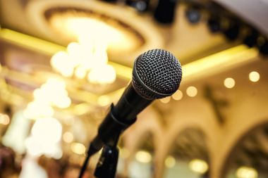 Microphone. A microphone on stage. A pub. Bar. Restaurant. Classic. Evening. Night show. European restaurant. European bar. American restaurant. American bar.