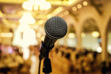 Microphone. A microphone on stage. A pub. Bar. Restaurant. Classic. Evening. Night show. European restaurant. European bar. American restaurant. American bar.