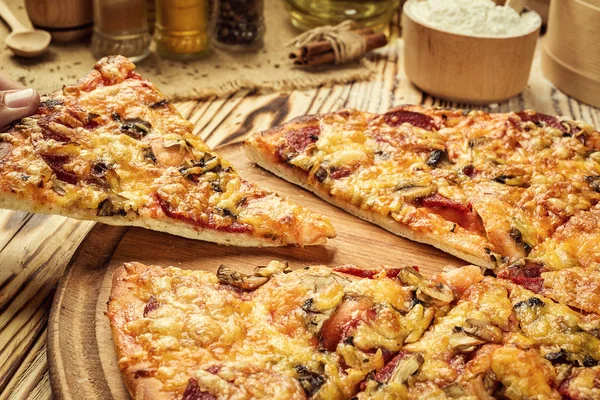 Hot pizza slice with melting cheese on a rustic wooden table.pepperoni pizza,Hot Homemade Pepperoni Pizza Ready to Eat,Supreme Pizza lifted slice,Delicious cheese stringy slice lifted of full supreme pizza,Margherita