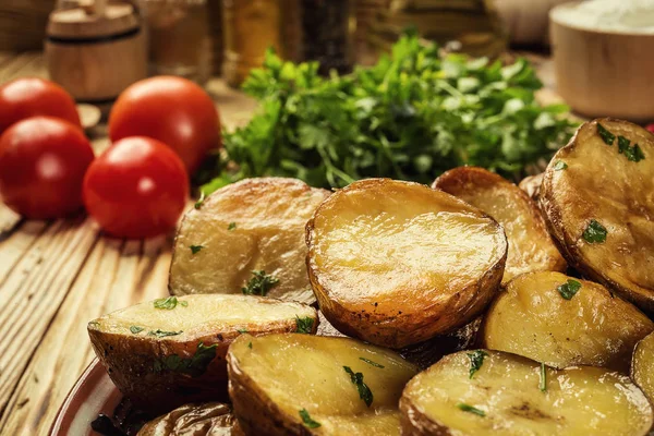 Sıcak buğulaması yakın fırında patates, sıcak tereyağlı ceket pişmiş patates, kavrulmuş patates kase ahşap masa üzerinde deniz tuzu ve biberiye, kızarmış patates fırında pişmiş patates otlar ile strewed.