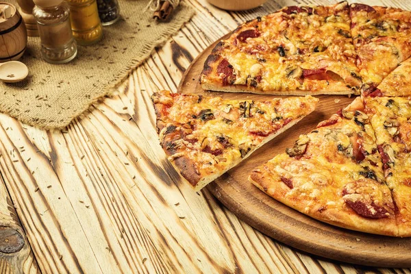 Hot pizza slice with melting cheese on a rustic wooden table.pepperoni pizza,Hot Homemade Pepperoni Pizza Ready to Eat,Supreme Pizza lifted slice,Delicious cheese stringy slice lifted of full supreme pizza,Margherita