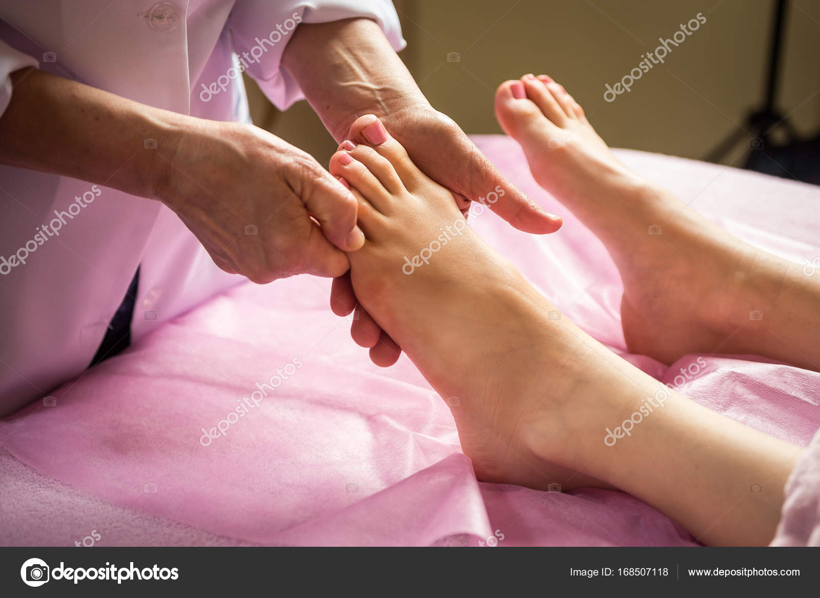 Foot massage in spa salon, closeup,Young woman having feet massage in
