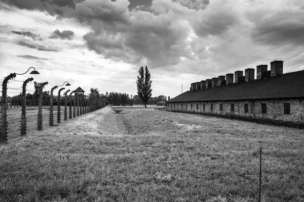 Auschwitz, Lengyelország - július 11-én, 2017.Barracks és a szögesdrót, a koncentrációs tábor, Auschwitz (Lengyelország). Múzeum Auschwitz - Birkenau.Barbed vezetékes, ezen a környéken: egy koncentrációs tábor. — Stock Fotó