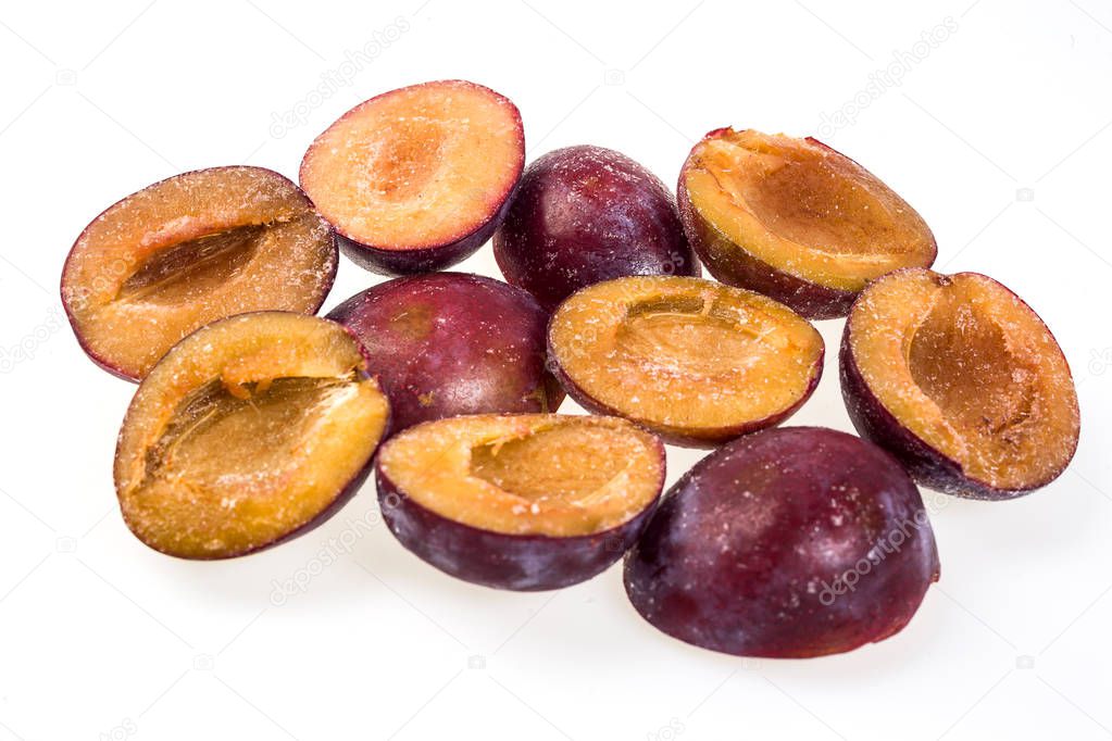 luscious frozen plum without pit isolated on white background, delicious first class organic fruit as a concept of summer vitamins