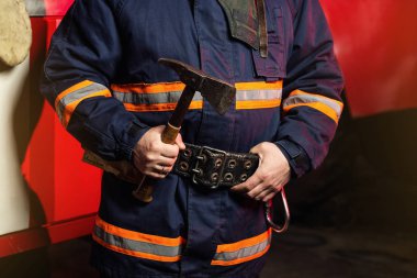 İtfaiyeci (itfaiye) eylem daimi bir firetruck yakınındaki. Acil durum Emanet. Koruma, tehlikeden kurtarmak.