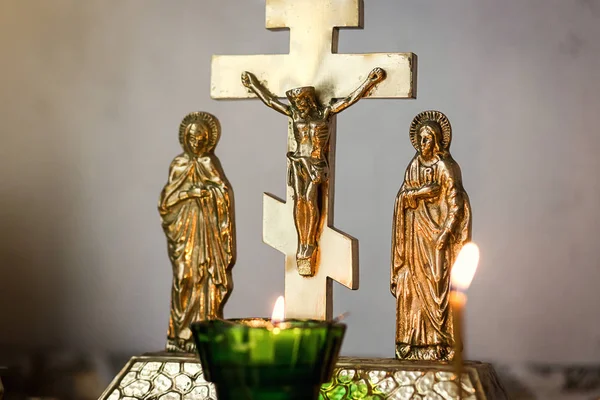 Cross with a crucifix on a background of burning candles Stock Picture