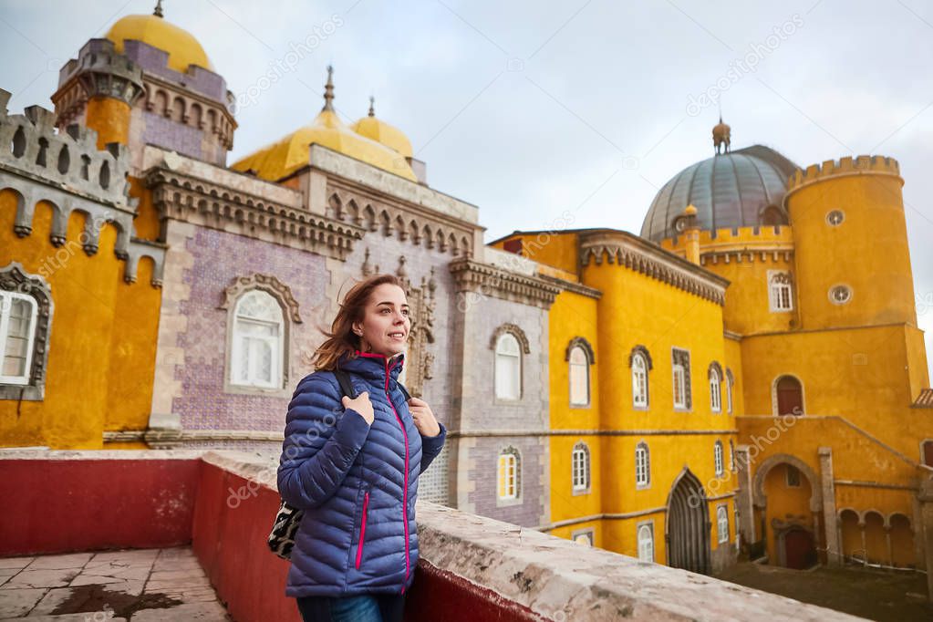 Young woman tourist walks in Pena Palace, Sintra, Portugal . Travel and tourism in Europe