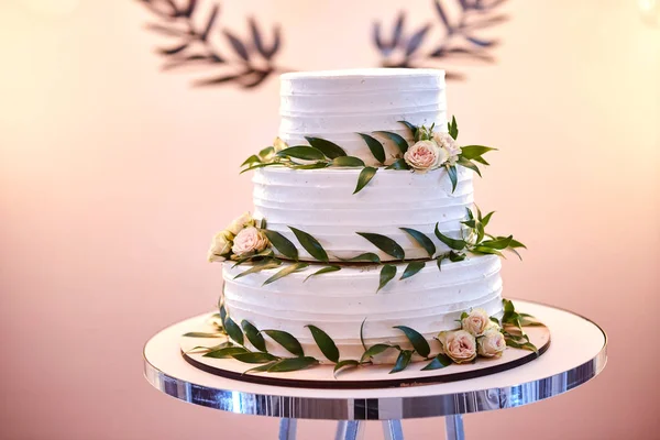 wedding festive multi-storey cake in white tone decorated with beautiful flowers