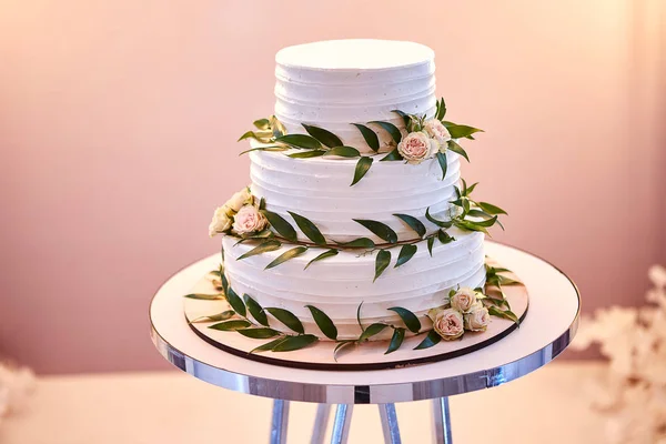 wedding festive multi-storey cake in white tone decorated with beautiful flowers
