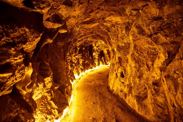 Underground tunnel in Quinta da Regaleira with lighting. Mystical cave.