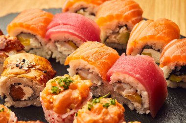 Siyah taşla servis edilen çeşitli suşi çeşitleri. Japon yemeği.