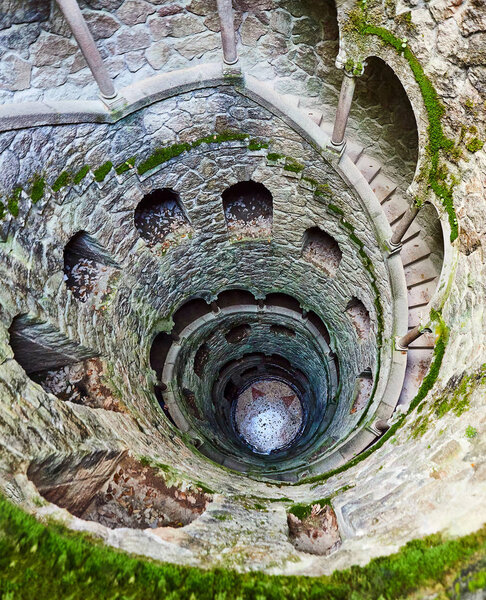 The Initiation well of Quinta da Regaleira It's a 27 meter staircase that leads straight down underground and connects with other tunnels via underground. located in Sintra, Portugal.