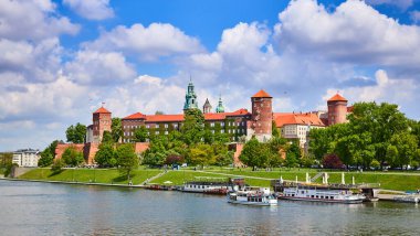 Wawel Kalesi - Krakow Polonya 'nın ünlü simgesi. Güneşli bir günde Vistula nehri kıyısındaki resim manzarası.