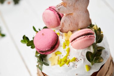 Beyaz ahşap arka planda Paskalya Tavşanı pastası geleneksel Kulich, Paska kutlamaya hazır.