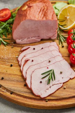 Baharatlı jambon, marul, avokado ve ahşap kesim tahtasında domates. Eski et tabağı. Taze jambon.