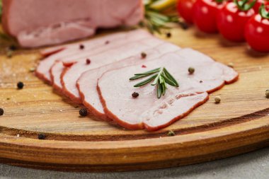 Baharatlı jambon, marul, avokado ve ahşap kesim tahtasında domates. Eski et tabağı. Taze jambon.