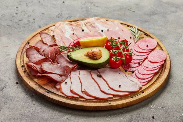 Appetizer from different types of meat delicacies such as  basturma, prosciutto crudo or spanish jamon and salami . A dish for a banquet