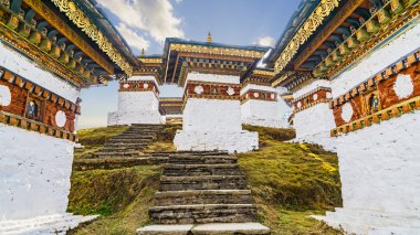 Dochula pass 108 chortens (Asian stupas) is the memorial in honour of the Bhutanese soldiers  in the Timpu city with the grass landscape and cloudy sky background, Bhutan clipart