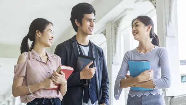 The group of people students with the book and stationary walk and talk in the smiling and happy — Stock Photo, Image