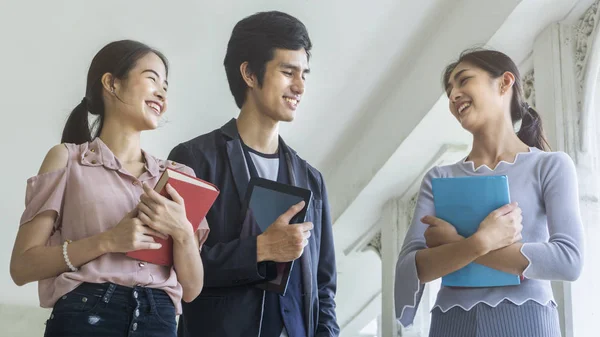 The group of people students with the book and stationary walk and talk in the smiling and happy — Stock Photo, Image