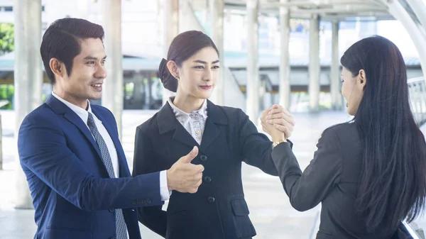 group of business people of man and woman stand and hold hands