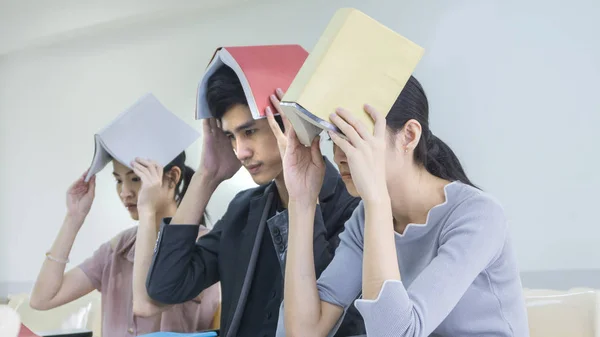 Student ludzi czytać książki, przytrzymaj nad głową i siedzieć wykład chai — Zdjęcie stockowe