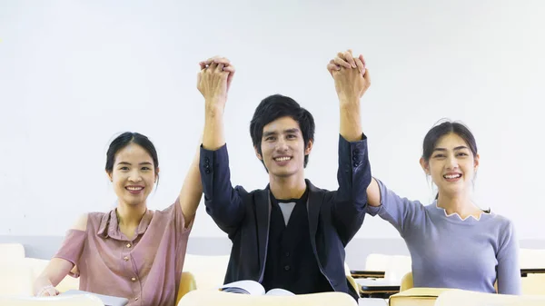 Young people push hand up in the indoor room — Stock Photo, Image