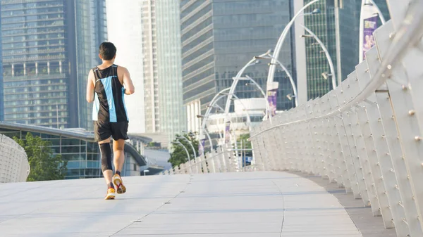 people run in city pedestrian bridge with exterior modern building