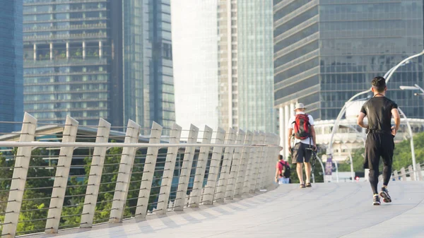 tourist and people run in city pedestrian bridge with exterior m