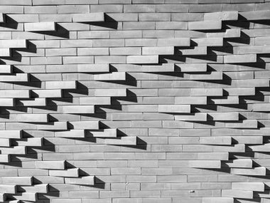 beton tuğla arka plan ışığı ile duvar ve tuğla cephe dış binadan kalıptan çekilmiş dalga hareketinin grup desende üzerinde gölge.