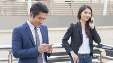 Grup girişimci insan seyir akıllı telefon mobil kullanır. Giyen genç yakışıklı iş adamları kesinlikle zarif elbise.