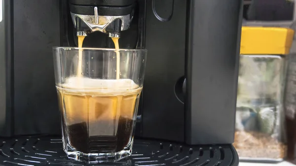 Cup of coffee with drop of water from bean to coffee machine in