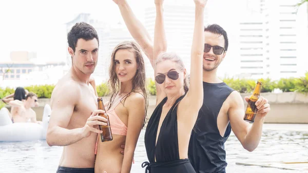 Group of people in swimming bikini nude dance and party in water pool with beverage of bottle of beer — Stock Photo, Image