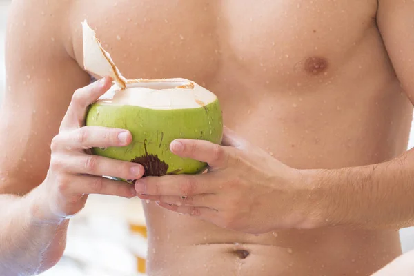 wet muscle chest white man nude topless with coconut drink