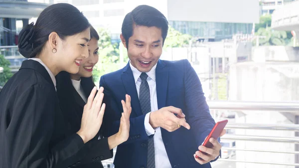 group smart business people of man and woman talk together and video call yourself in feeling happy with tablet smart phone device at the outdoor pedestrian walkway space in the morning.