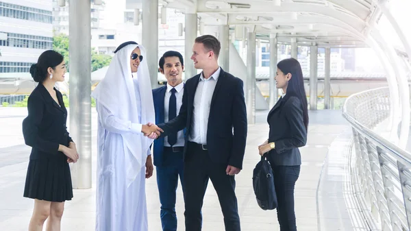 group of global business people man and woman talk and shake hands for business negotiations in feeling success and happy with the city space background in the outdoor