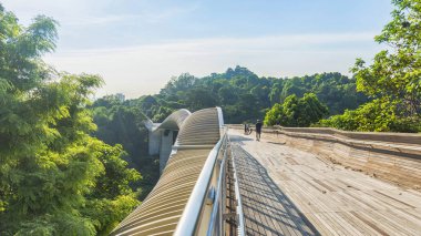 ahşap köprü geçit gölge güneş ışığı orman ağacı yeşil alanın kentsel modern şehir ve mavi gökyüzü beyaz bulut üzerinde çelik yapısı ile insanlarda