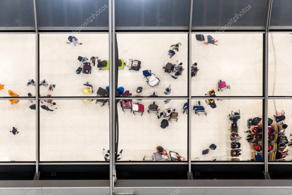 reflection glass of top view people in line queue with luggage and briefcase to travel at airport