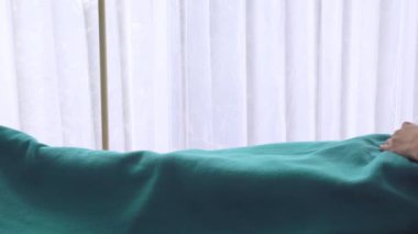 Asyalı kadın doktor, yaşlı yaşlı bir hastaya tavsiye veriyor. Tekerlekli sandalyede, hasta odasında oturuyor. Hastanenin arka plan beyaz perdesi..