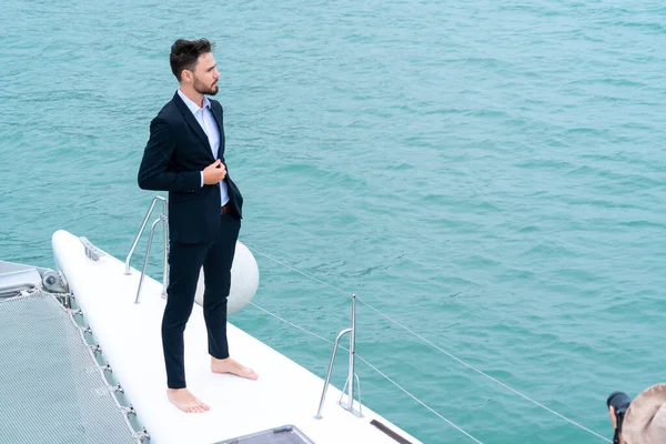 businessman with smart phone on cruise yacht with background of sea and white sky. Concept business travel.