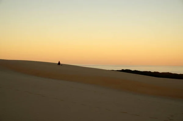Meditating in the sand dunes — Stock Photo, Image
