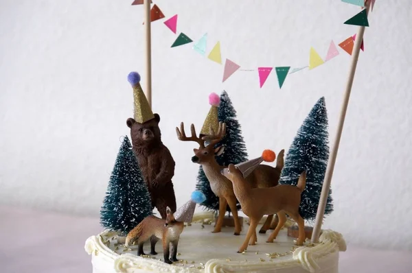 White cake with forest animals decoration