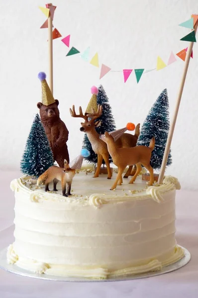 White cake with forest animals decoration