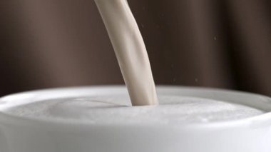 Sütlü kapuçino Kupası ağır çekimde dökme